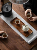 Acacia wood tea tray with tea set on wooden table